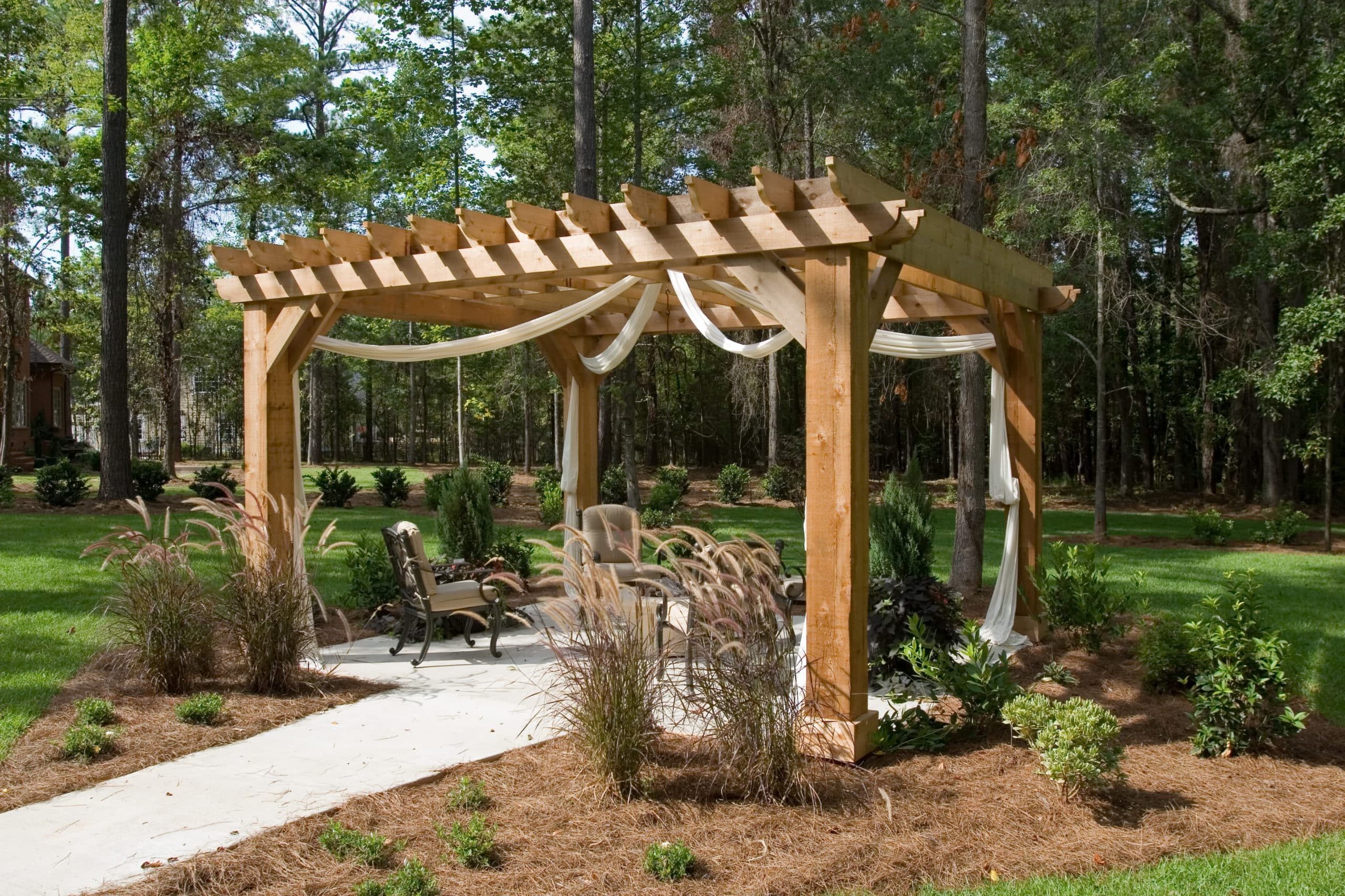 Outdoor living space with a wooden pergola and landscaped patio