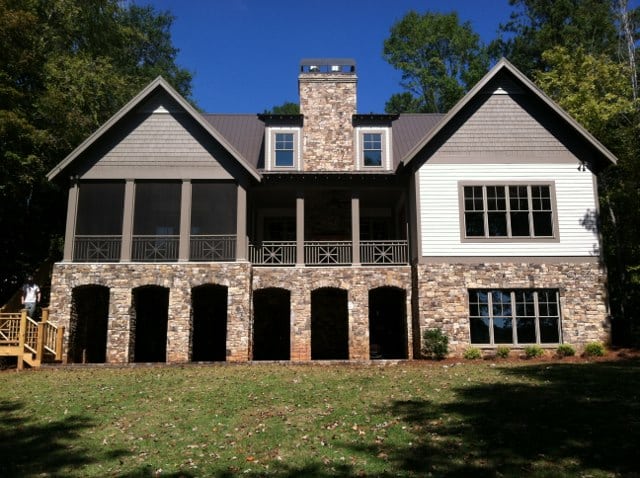 Stone-and-siding home exterior with a covered lower level